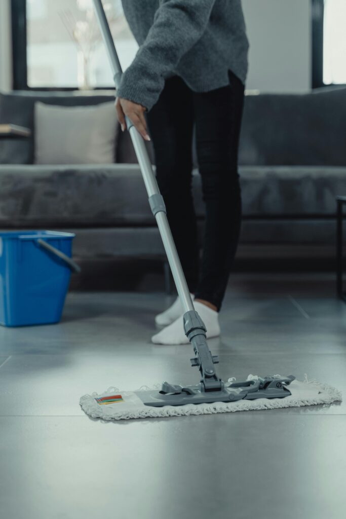same-day cleaning Houston mopping floors in living area
