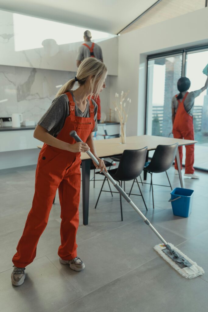 fast house cleaning team mopping floors in modern home